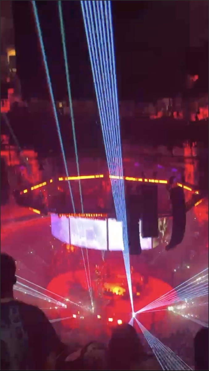 Laser lights over a packed arena.